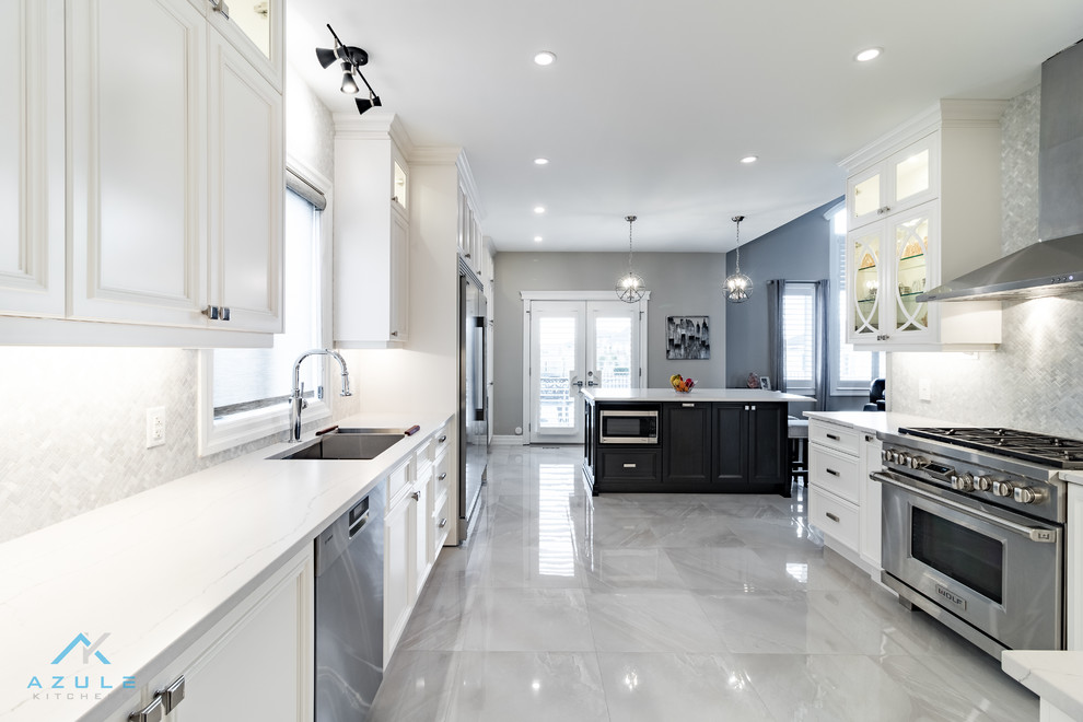 Large transitional u-shaped porcelain tile enclosed kitchen photo with recessed-panel cabinets, white cabinets, quartz countertops, white backsplash, marble backsplash, stainless steel appliances, an island and white countertops