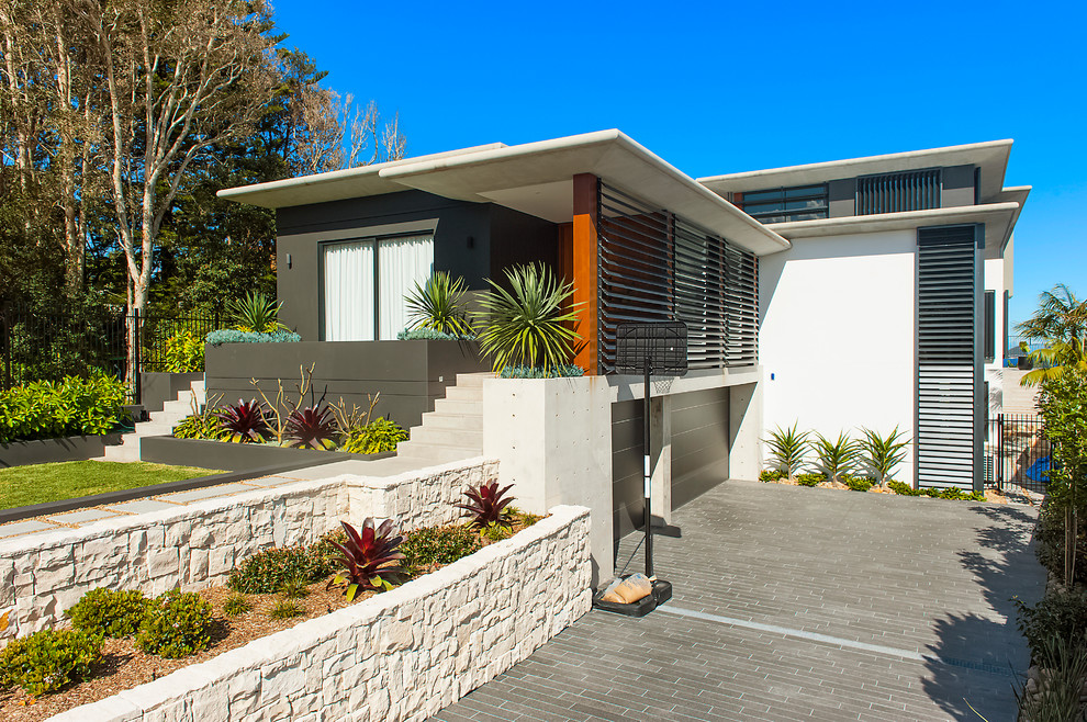 Design ideas for a contemporary two-storey exterior in Sydney with a flat roof.