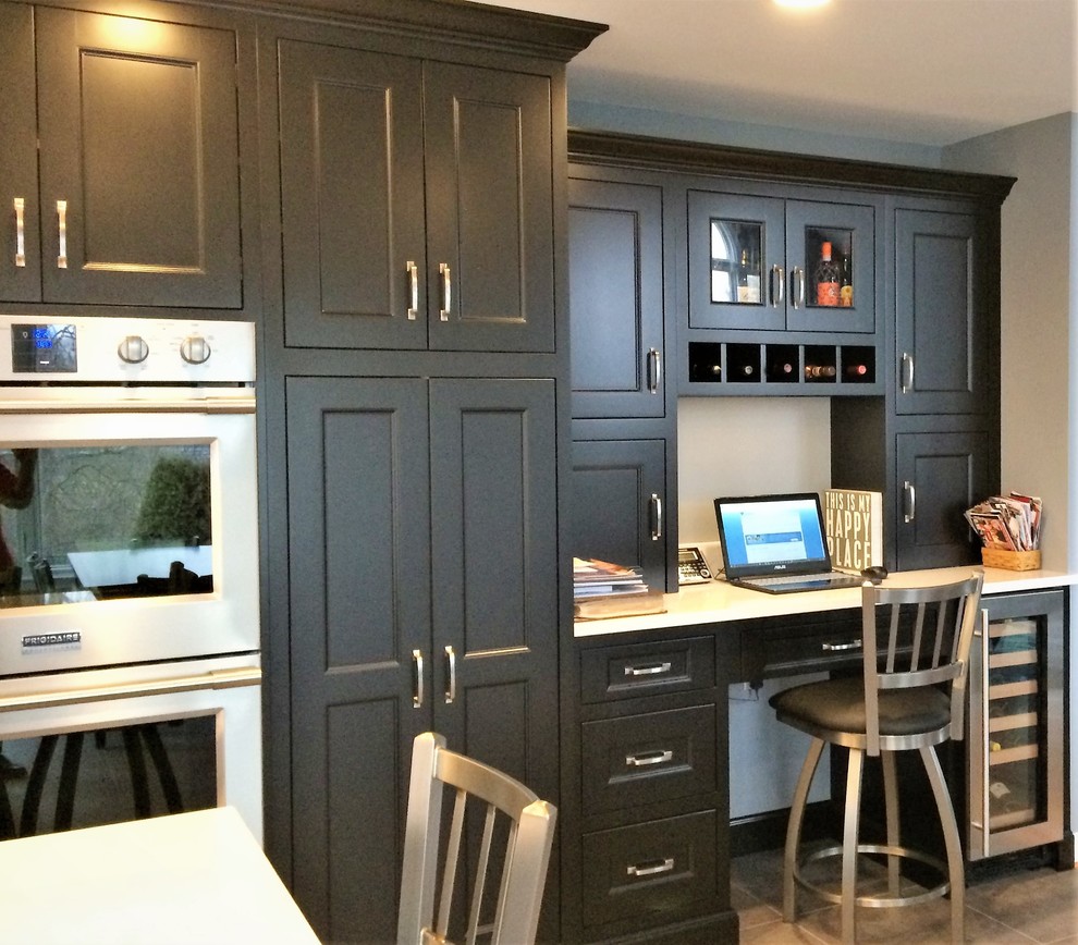 Inspiration for a large transitional galley porcelain tile and gray floor open concept kitchen remodel with an undermount sink, recessed-panel cabinets, white cabinets, quartz countertops, blue backsplash, mosaic tile backsplash, stainless steel appliances, an island and black countertops