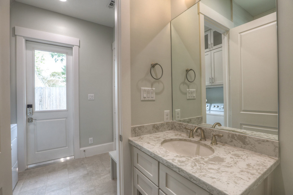 Example of a mid-sized transitional 3/4 corner shower design in Houston with shaker cabinets, an undermount sink, a hinged shower door, gray cabinets, a one-piece toilet and quartz countertops
