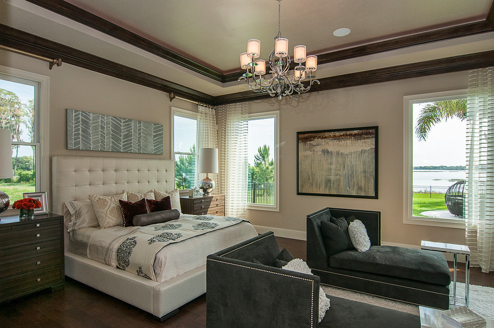 Photo of a large transitional master bedroom in Orlando with beige walls, dark hardwood floors and brown floor.