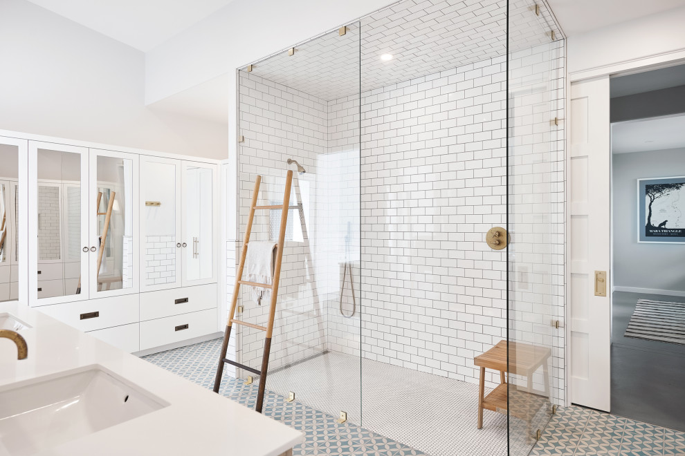 Inspiration for an expansive modern master bathroom in Grand Rapids with a curbless shower, white tile, subway tile, white walls, ceramic floors, white floor, a hinged shower door and white benchtops.