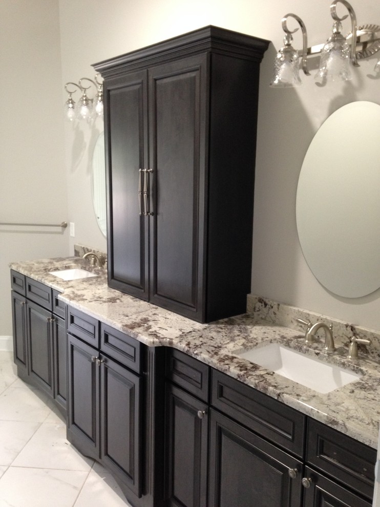 Design ideas for a mid-sized traditional master bathroom in Other with raised-panel cabinets, black cabinets, grey walls, porcelain floors, an undermount sink and granite benchtops.