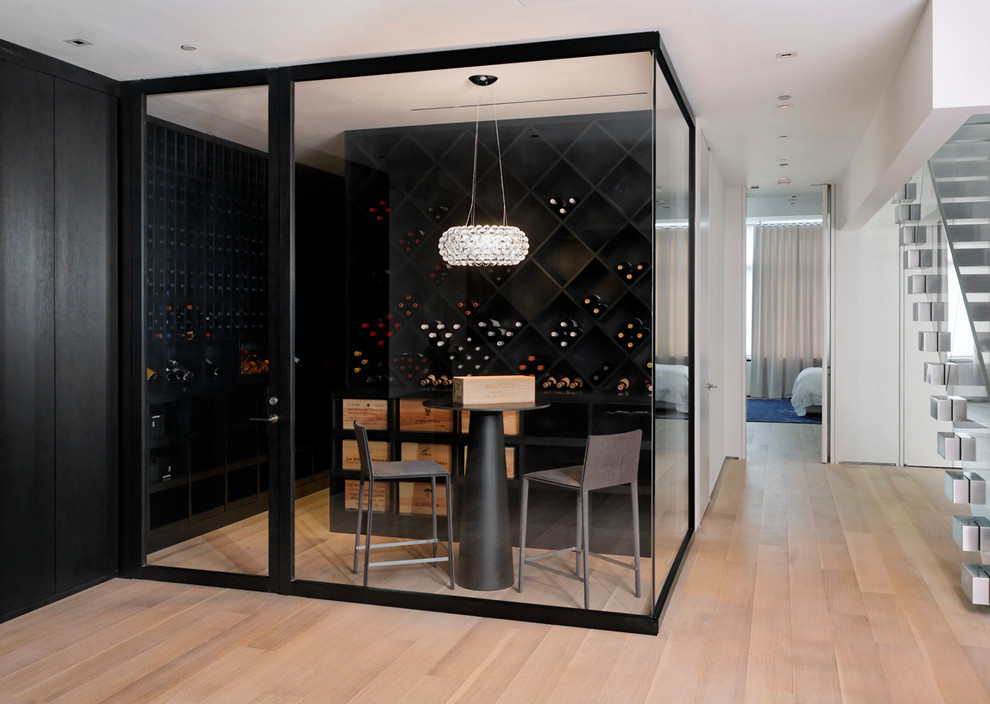 Modern wine cellar in New York with light hardwood floors, diamond bins and beige floor.
