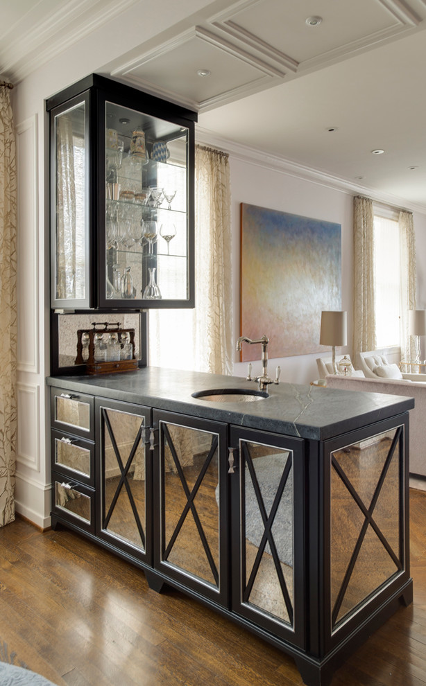 Inspiration for a mid-sized contemporary single-wall wet bar in Philadelphia with medium hardwood floors, an undermount sink, black cabinets, soapstone benchtops and mirror splashback.