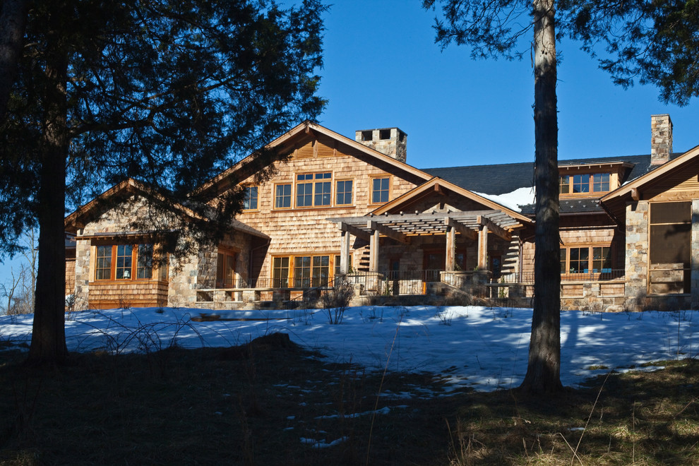 Example of a mountain style brown two-story stone exterior home design