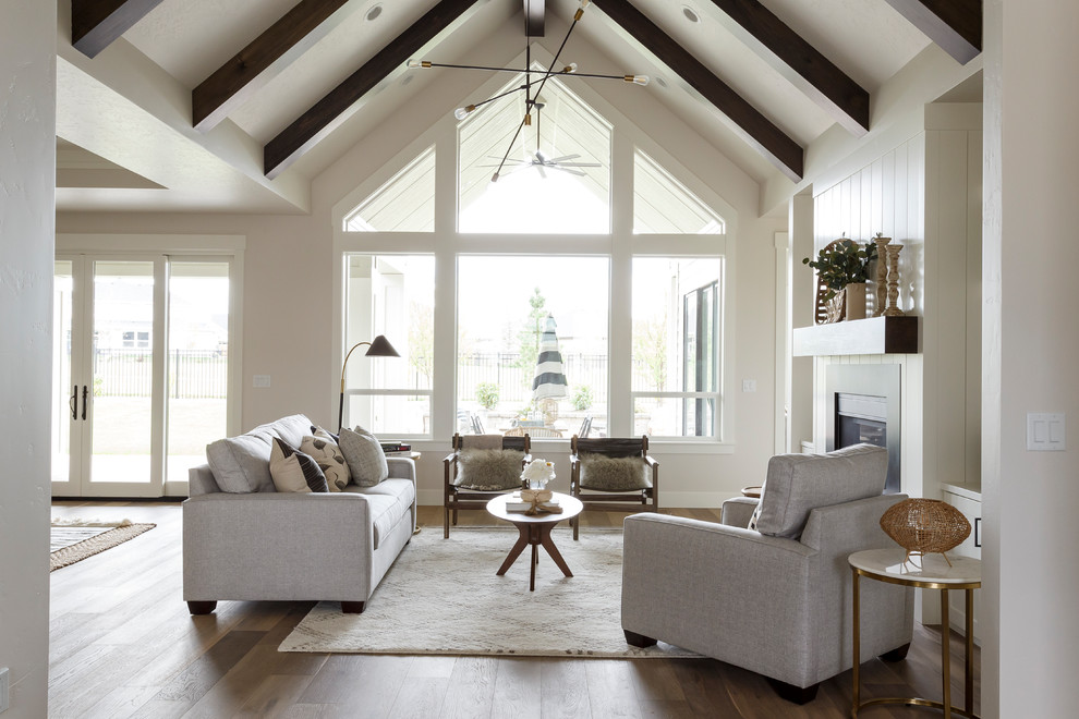 Design ideas for a country formal open concept living room in Boise with grey walls, medium hardwood floors, a standard fireplace and no tv.