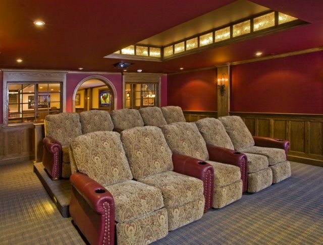 Design ideas for a large traditional enclosed home theatre in Philadelphia with red walls, carpet, a projector screen and multi-coloured floor.