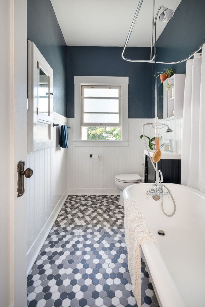 Inspiration for a small mediterranean ensuite bathroom in San Francisco with shaker cabinets, dark wood cabinets, a claw-foot bath, an integrated sink, solid surface worktops, multi-coloured floors, white worktops, a single sink, a freestanding vanity unit and wainscoting.
