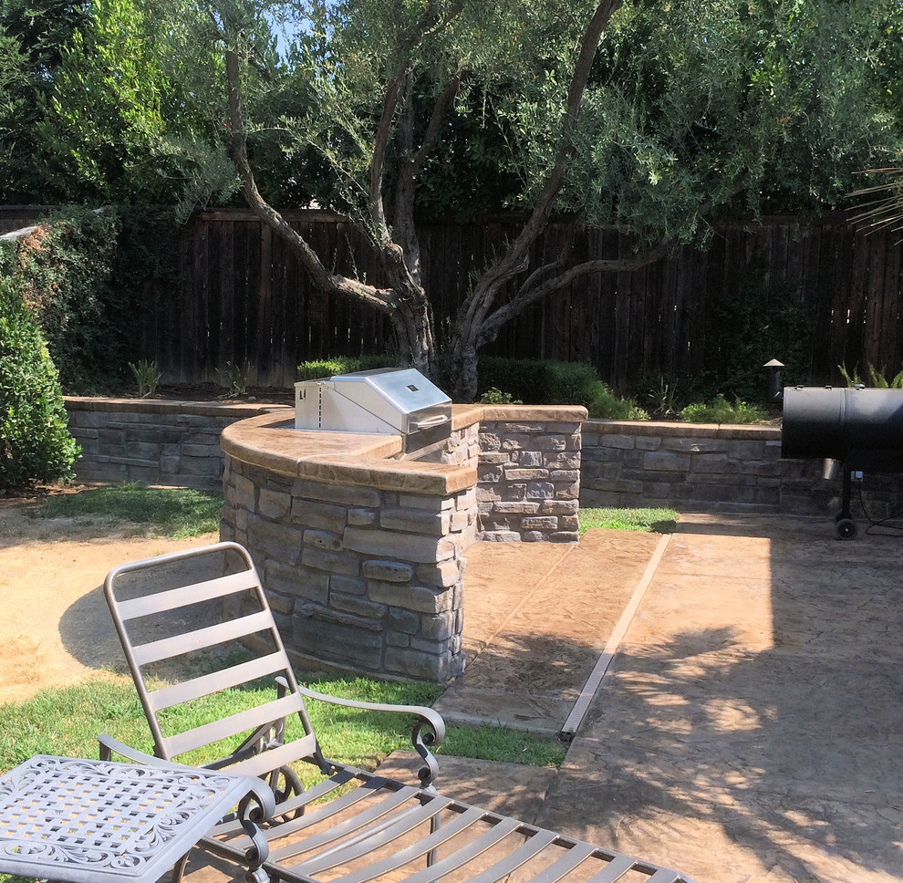 Photo of a large mediterranean backyard patio in Other with an outdoor kitchen, stamped concrete and a gazebo/cabana.