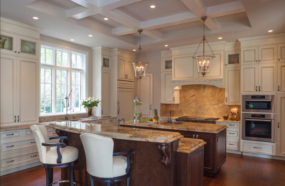 Example of a mid-sized classic laminate floor eat-in kitchen design with flat-panel cabinets, two islands, white cabinets, granite countertops and brown backsplash