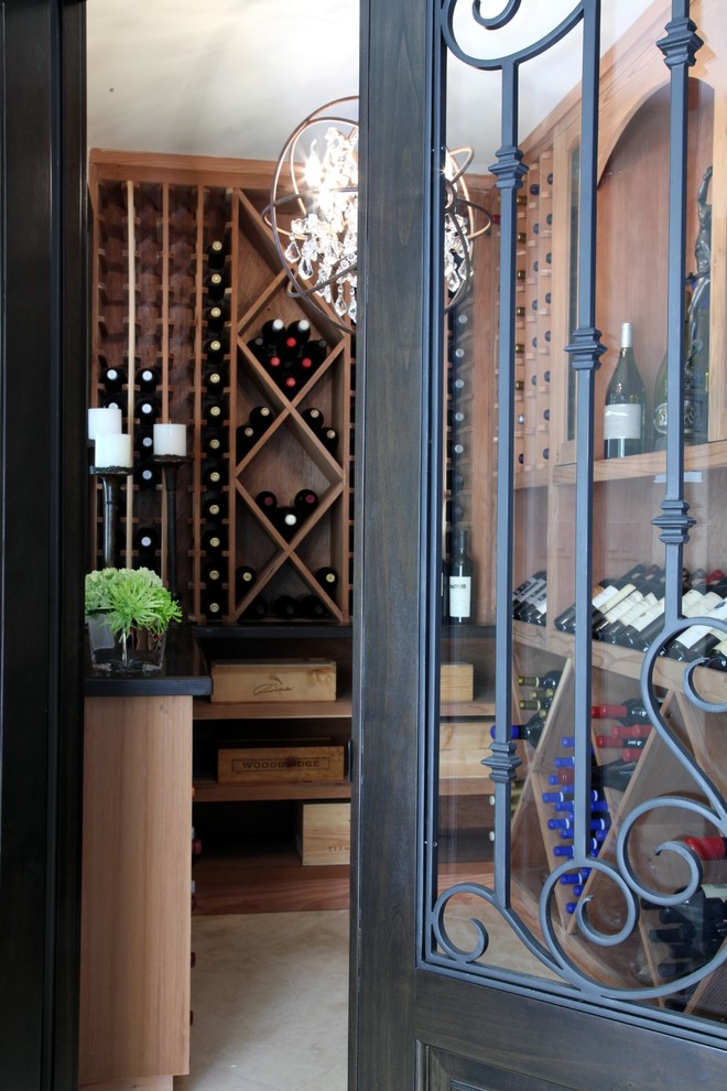 Design ideas for a traditional wine cellar in Los Angeles with travertine floors.