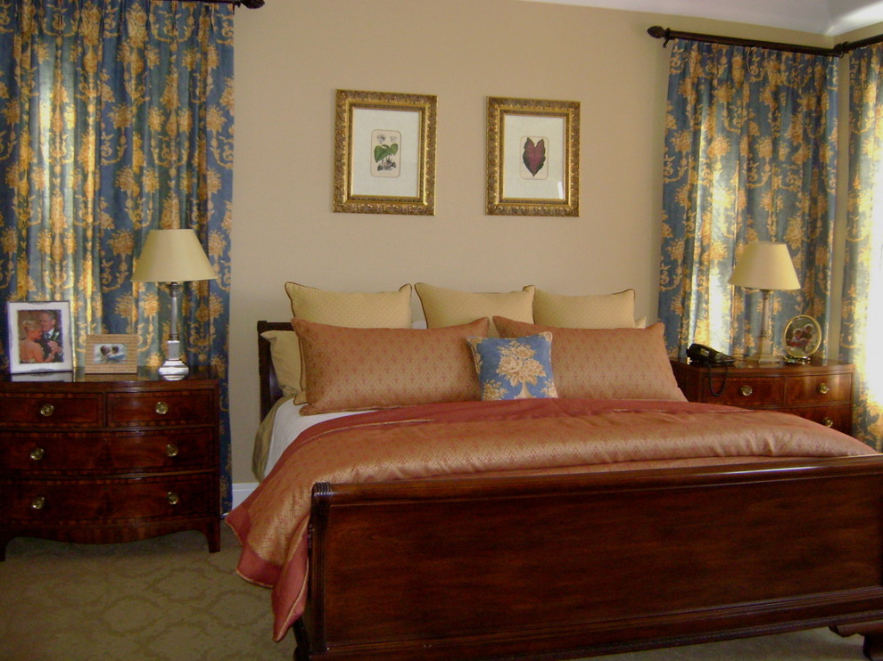 Design ideas for a large traditional master bedroom in New York with beige walls and carpet.