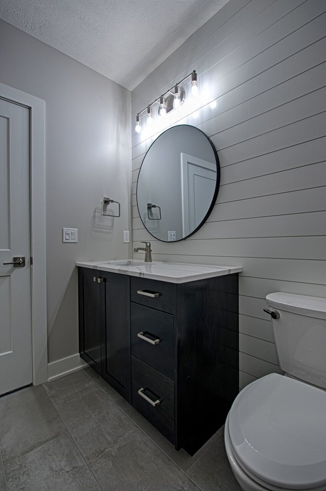Transitional gray tile cement tile floor and gray floor home design photo with shaker cabinets, white cabinets, an undermount sink and wood countertops