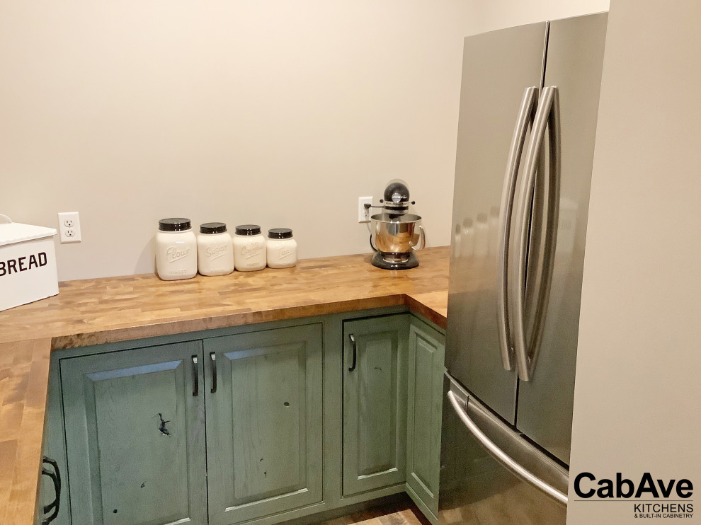 Inspiration for a mid-sized rustic u-shaped ceramic tile and beige floor open concept kitchen remodel in New York with a farmhouse sink, raised-panel cabinets, blue cabinets, wood countertops, stainless steel appliances, a peninsula and brown countertops