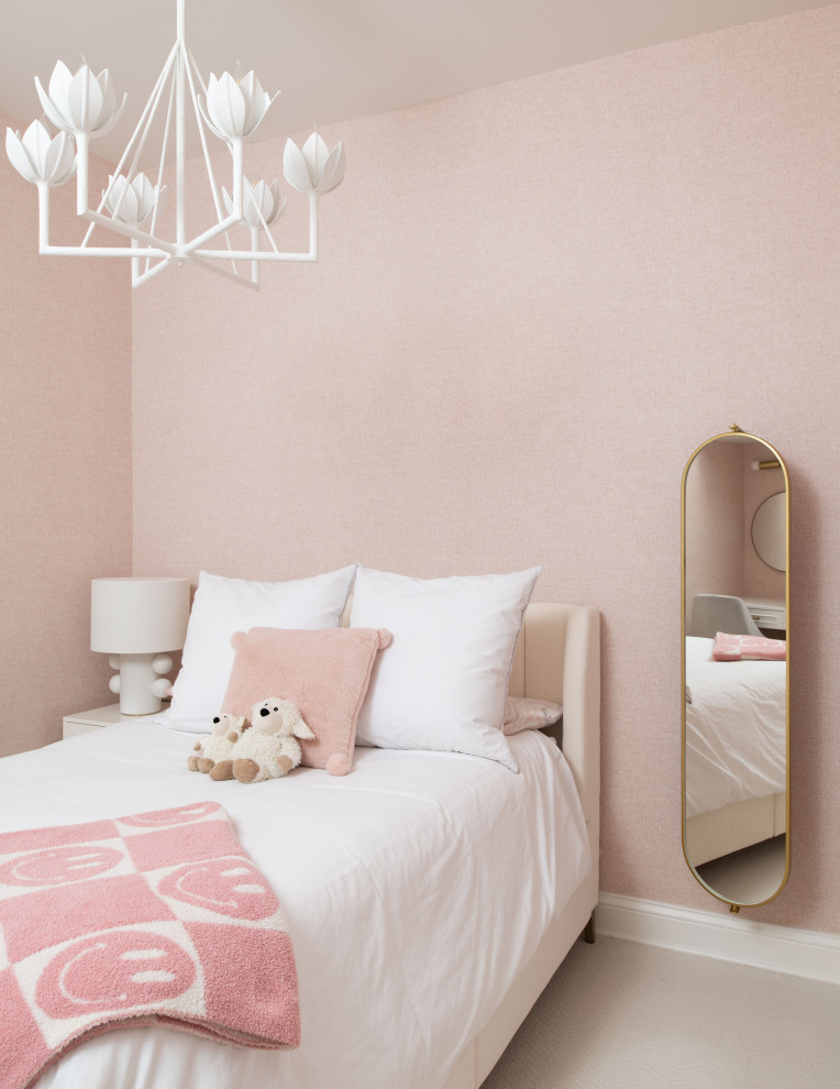 This is an example of a transitional kids' bedroom for kids 4-10 years old and girls in Chicago with pink walls, carpet and beige floor.