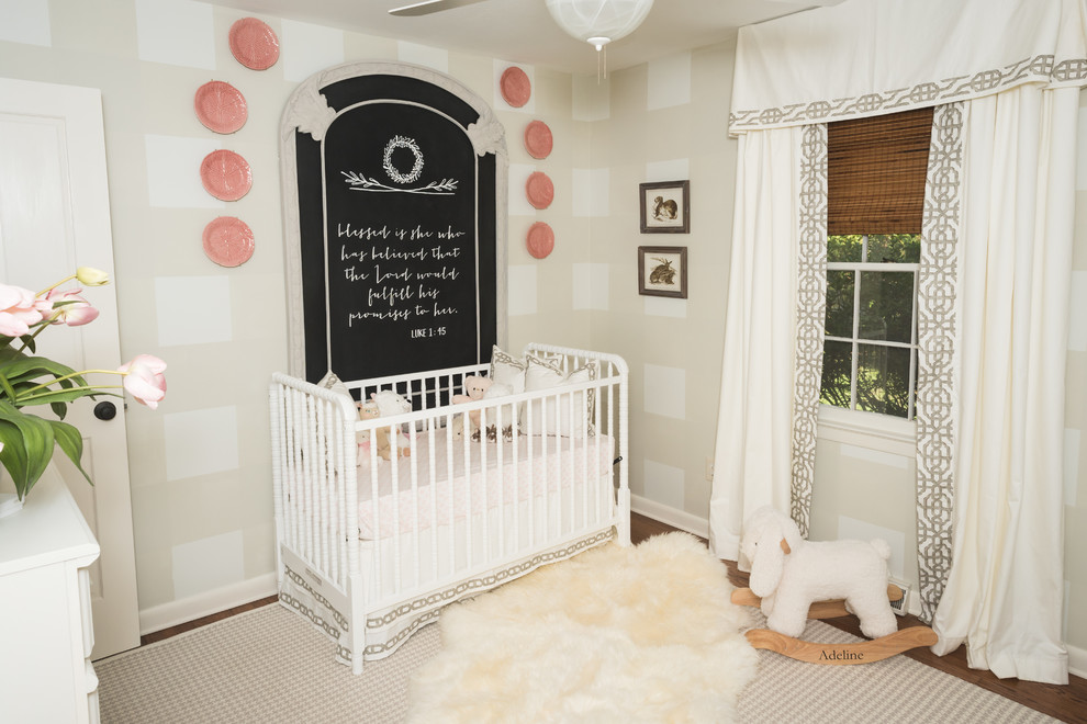 Design ideas for a small traditional nursery for girls in Charleston with beige walls, medium hardwood floors and brown floor.