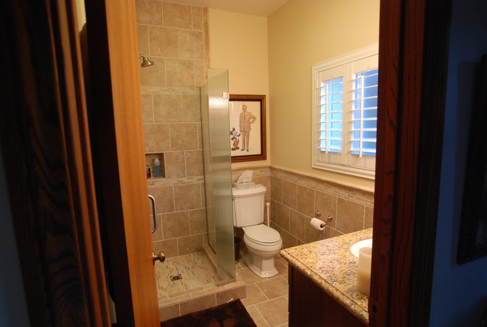 Corner shower - small modern 3/4 beige tile and porcelain tile porcelain tile corner shower idea in Orange County with an undermount sink, dark wood cabinets, granite countertops, a two-piece toilet and beige walls