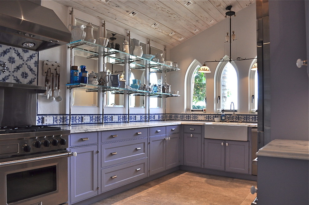 This is an example of a large traditional u-shaped separate kitchen in Other with a farmhouse sink, beaded inset cabinets, marble benchtops, multi-coloured splashback, ceramic splashback, stainless steel appliances, limestone floors and grey cabinets.