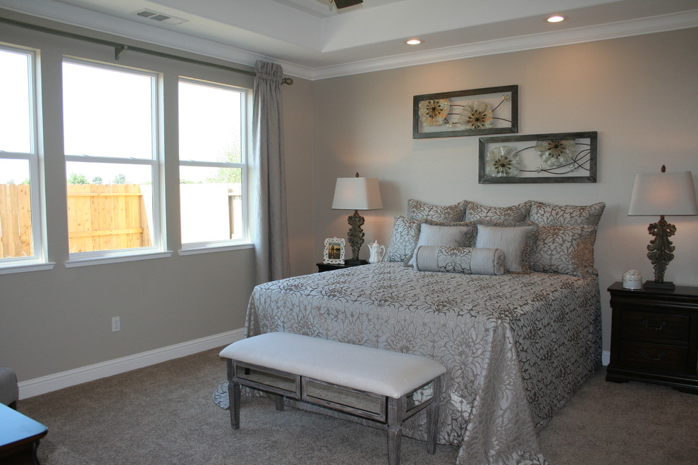 This is an example of a large eclectic master bedroom in Sacramento with grey walls and carpet.