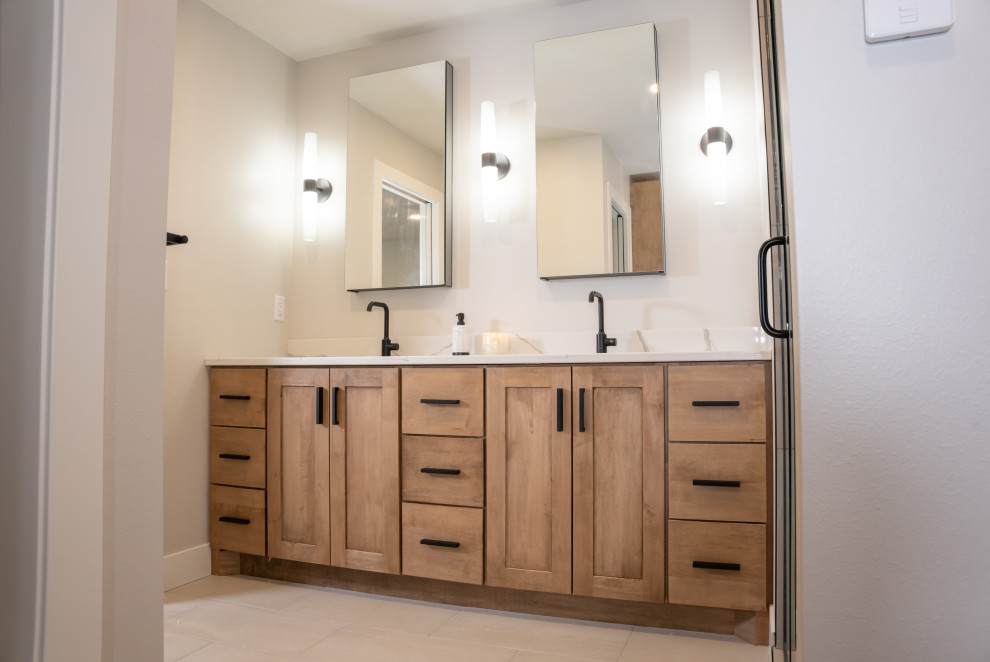 Exemple d'une salle de bain chic en bois clair de taille moyenne avec un placard à porte shaker, un lavabo encastré et meuble double vasque.