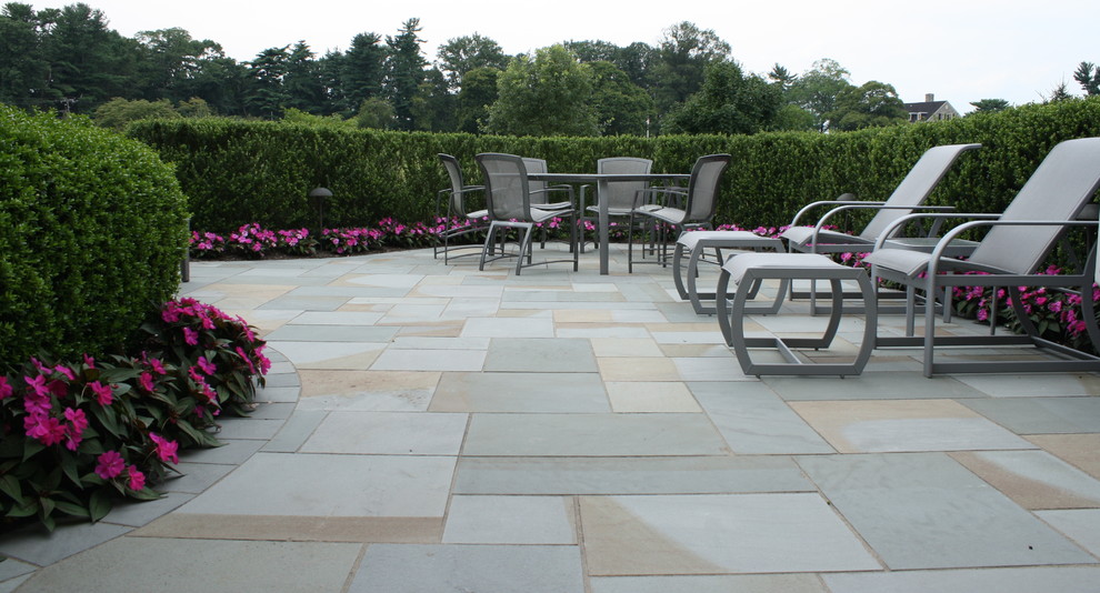 Inspiration for a small traditional back patio in Philadelphia with natural stone paving.