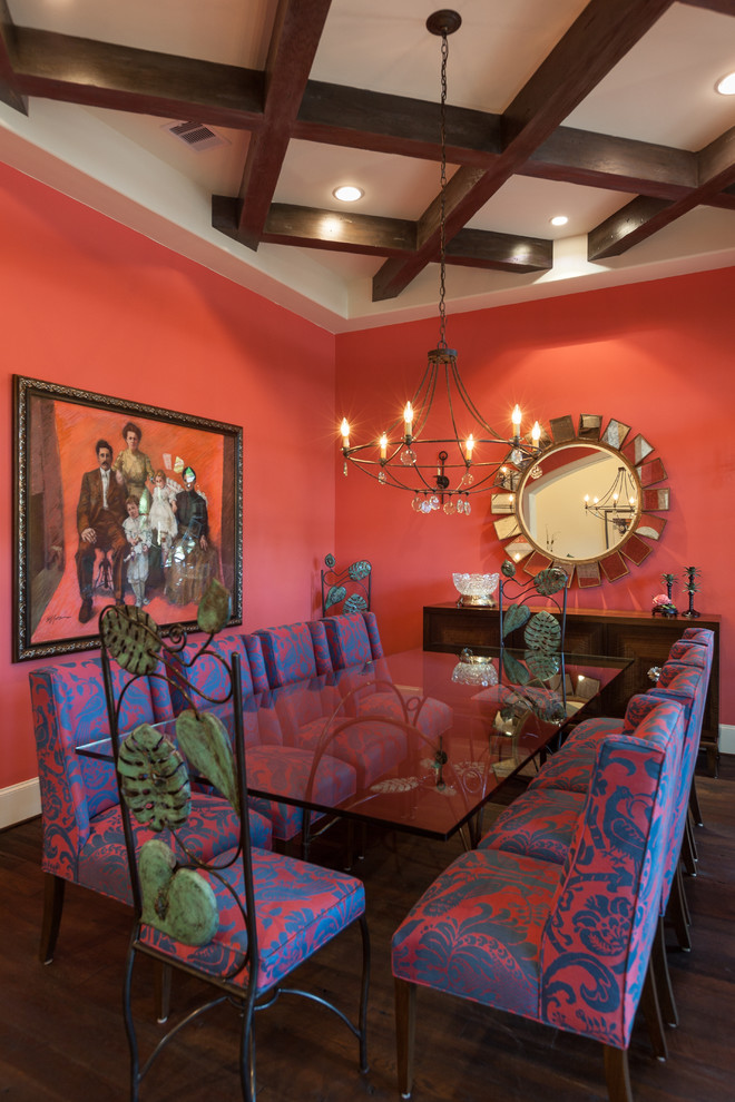 Photo of an eclectic dining room in Houston with dark hardwood floors and red walls.