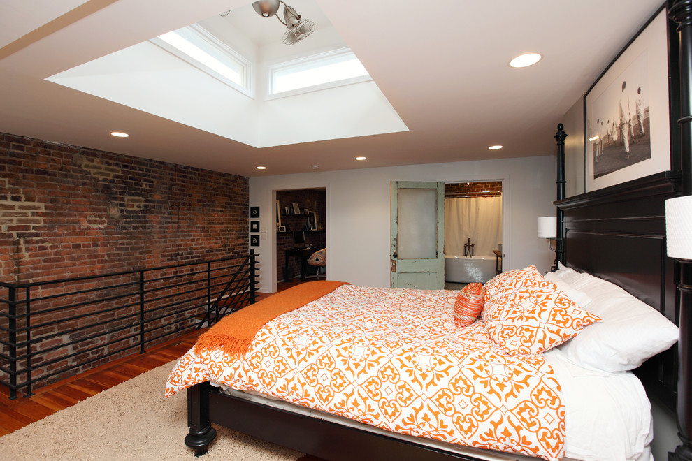 Design ideas for an industrial master bedroom in Richmond with white walls.