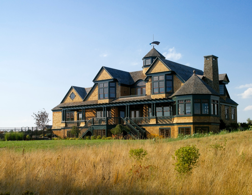 Inspiration for an expansive traditional three-storey brown exterior in Providence with wood siding.
