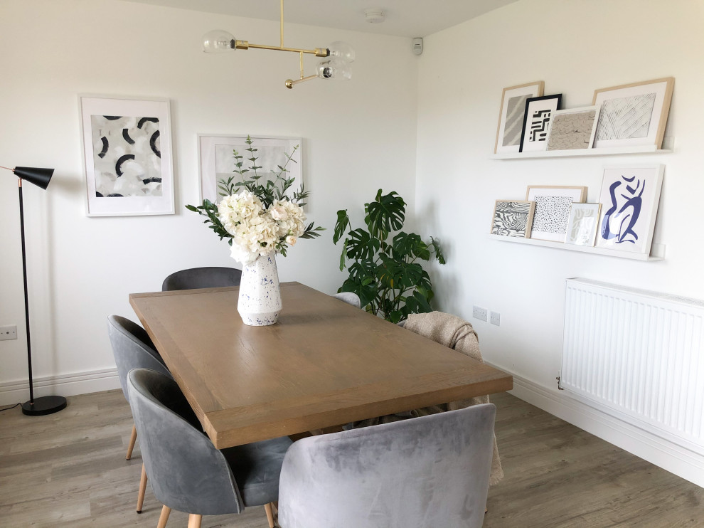This is an example of a small modern kitchen/dining combo in Edinburgh with white walls, vinyl floors and beige floor.