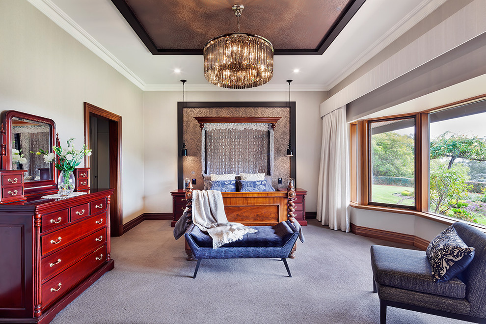 This is an example of a traditional bedroom in Adelaide with beige walls and carpet.