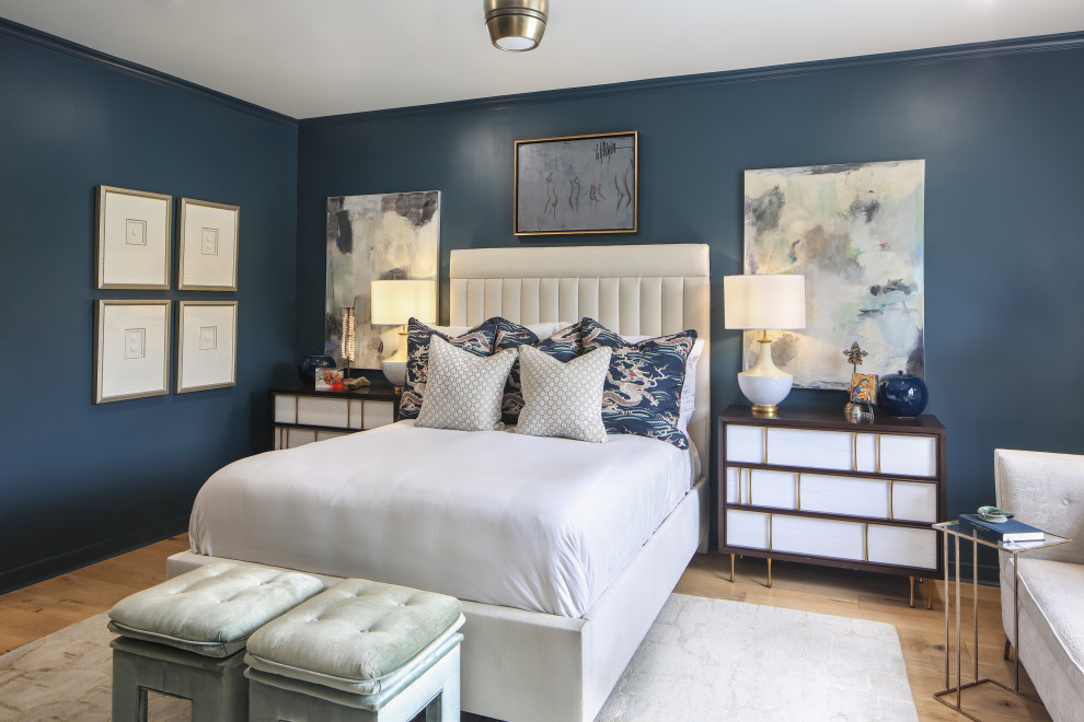 Large midcentury master bedroom in New Orleans with blue walls, medium hardwood floors and brown floor.