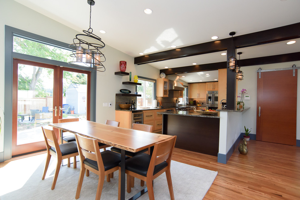 Design ideas for a mid-sized contemporary kitchen/dining combo in Seattle with white walls and porcelain floors.