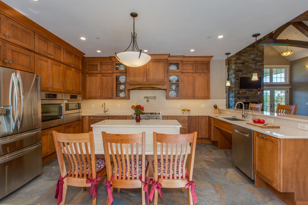 Example of a huge transitional u-shaped open concept kitchen design in Boston with an undermount sink, shaker cabinets, medium tone wood cabinets, quartz countertops, stone slab backsplash, stainless steel appliances and an island