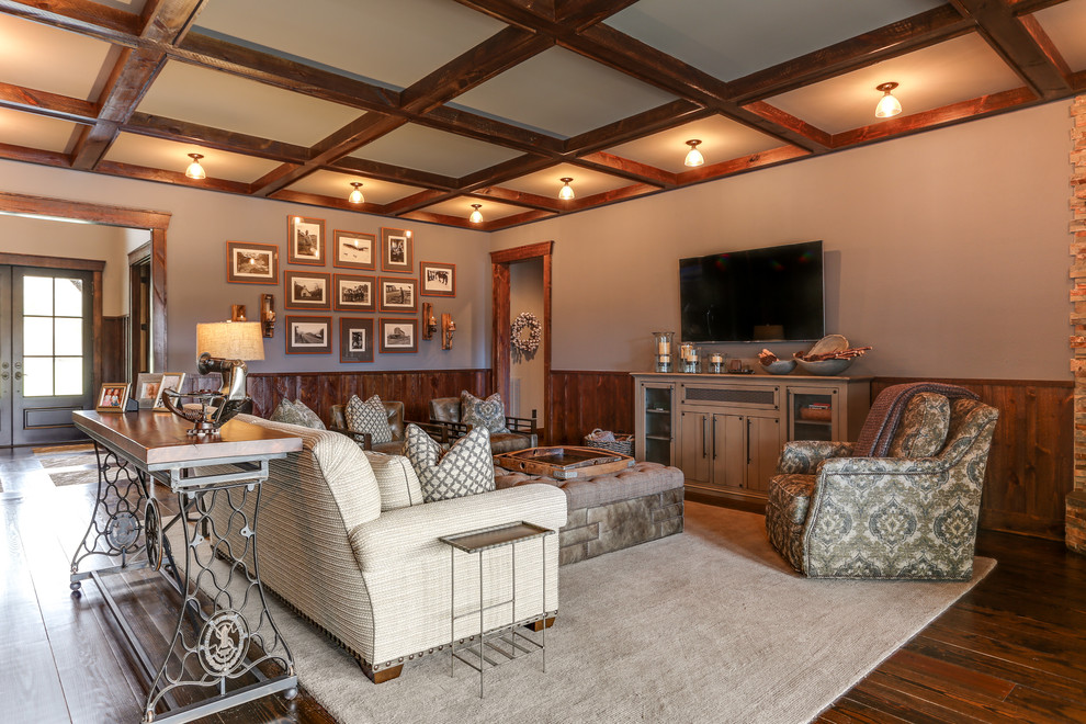 Photo of a large country open concept family room in Raleigh with dark hardwood floors, a stone fireplace surround, a wall-mounted tv, brown floor, grey walls and a corner fireplace.
