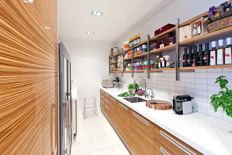 Inspiration for a small modern galley separate kitchen in Los Angeles with an undermount sink, open cabinets, medium wood cabinets, quartz benchtops, white splashback, ceramic splashback, stainless steel appliances, marble floors, no island and white floor.