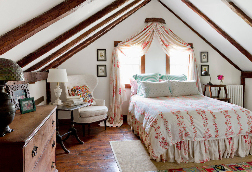 Country bedroom in New York with white walls and dark hardwood floors.