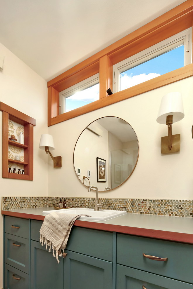 Design ideas for an arts and crafts master bathroom in Seattle with recessed-panel cabinets, blue cabinets, a double shower, a one-piece toilet, multi-coloured tile, glass tile, white walls, porcelain floors, a drop-in sink, laminate benchtops, white floor, a hinged shower door and green benchtops.