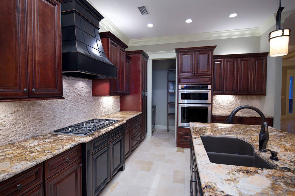 Design ideas for a mid-sized traditional single-wall open plan kitchen in Jacksonville with an undermount sink, raised-panel cabinets, red cabinets, granite benchtops, stainless steel appliances, travertine floors, with island, beige floor and brown benchtop.
