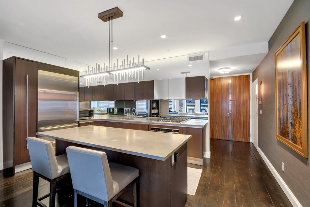 Mid-sized mountain style l-shaped dark wood floor and brown floor eat-in kitchen photo in New York with an undermount sink, flat-panel cabinets, dark wood cabinets, quartz countertops, multicolored backsplash, mirror backsplash, stainless steel appliances, an island and gray countertops
