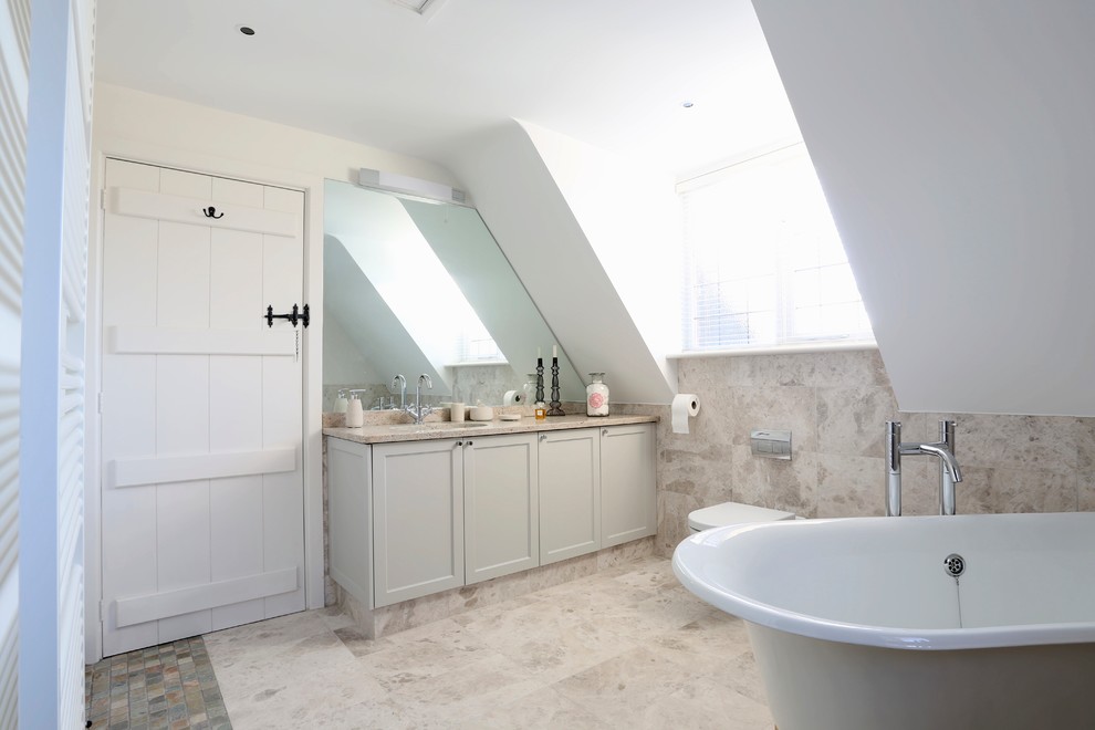 Inspiration for a transitional bathroom in Surrey with an undermount sink, a freestanding tub, an alcove shower, a wall-mount toilet, shaker cabinets, beige tile and ceramic tile.