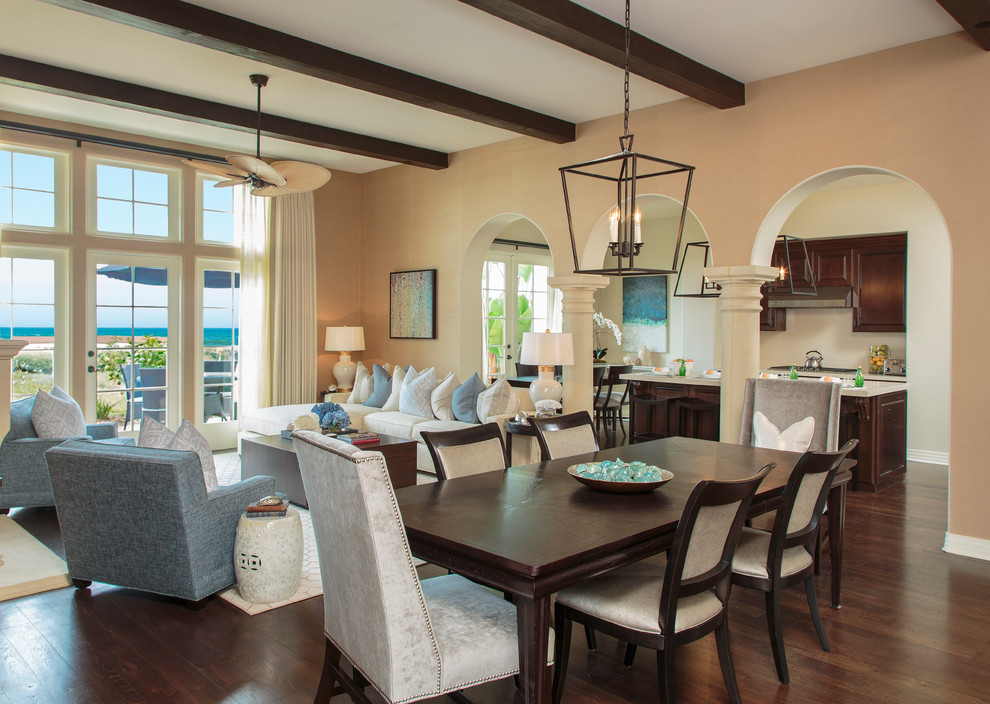 Large mediterranean open plan dining in Orange County with beige walls, dark hardwood floors and no fireplace.