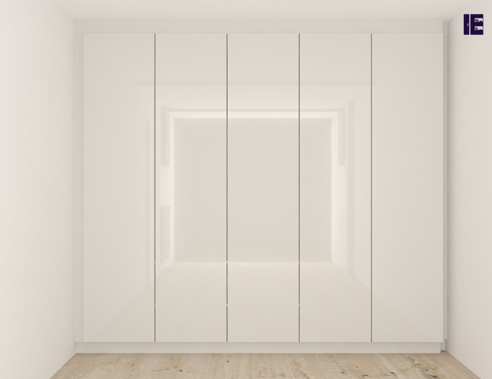 This is an example of a medium sized contemporary standard wardrobe in London with flat-panel cabinets and white cabinets.