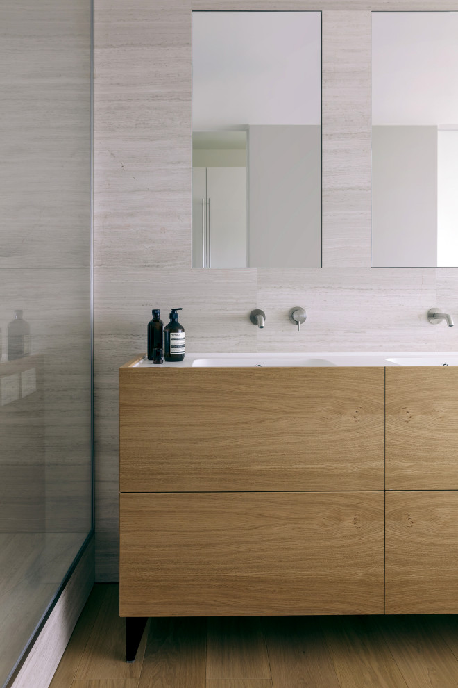 Inspiration for a large contemporary 3/4 bathroom in Milan with beaded inset cabinets, light wood cabinets, blue tile, mosaic tile, an integrated sink and a sliding shower screen.