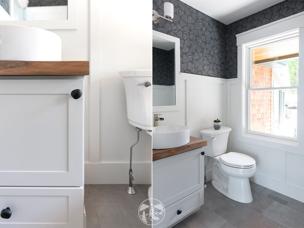 This is an example of a small rustic cloakroom in Other with shaker cabinets, white cabinets, a two-piece toilet, white walls, porcelain flooring, a vessel sink, wooden worktops, grey floors, brown worktops, a built in vanity unit and wainscoting.