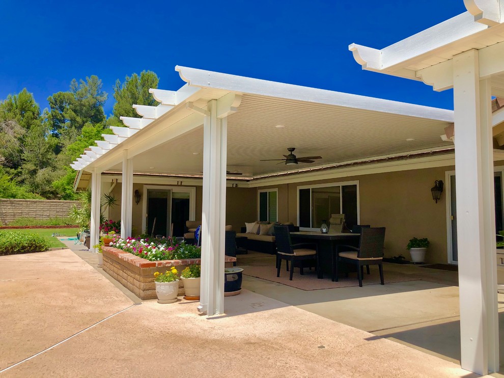 Inspiration for a large arts and crafts backyard patio in Orange County with stamped concrete and a pergola.