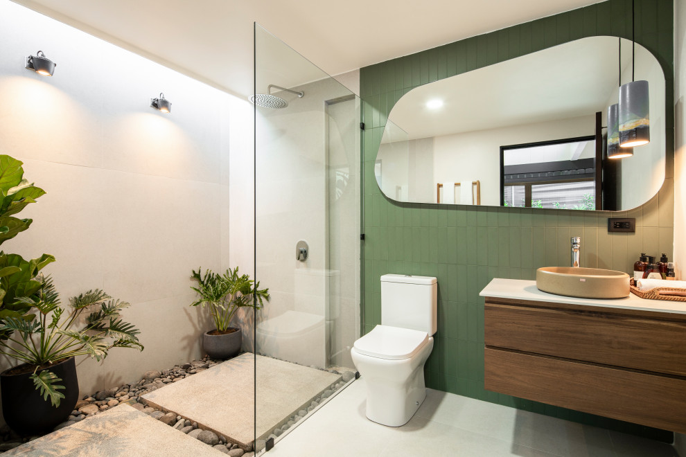 Tropical bathroom in Other with flat-panel cabinets, medium wood cabinets, a curbless shower, a vessel sink, grey floor, an open shower, white benchtops, a single vanity and a floating vanity.