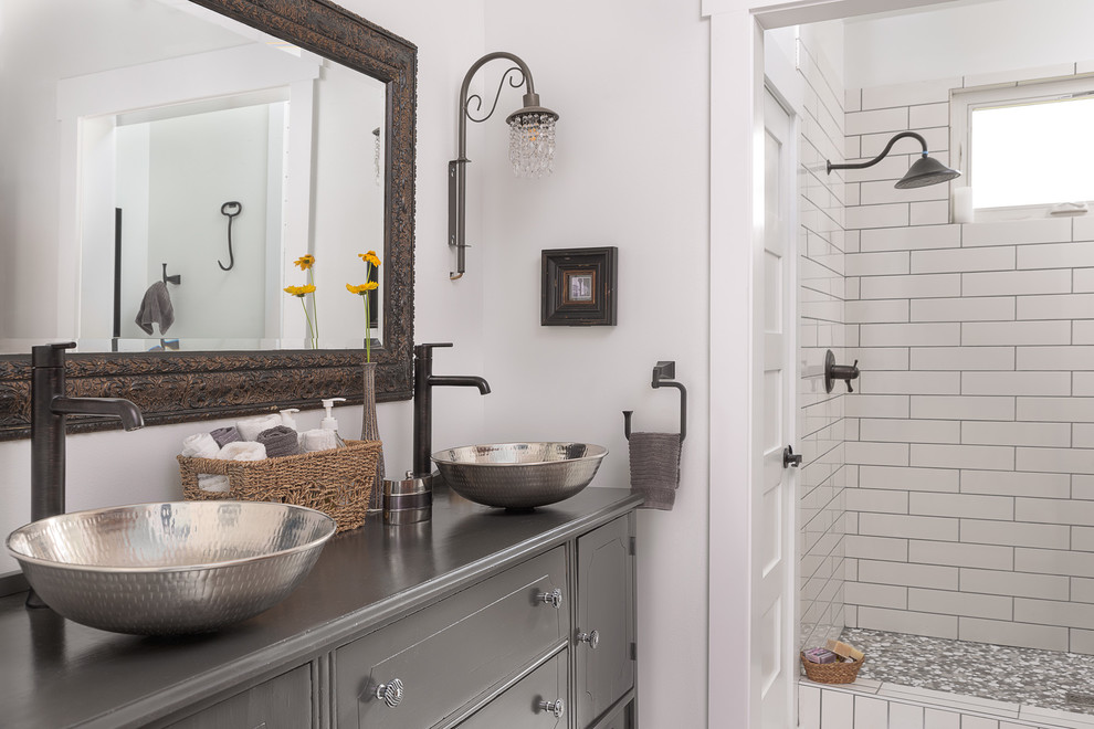 This is an example of a mid-sized country master bathroom in Other with furniture-like cabinets, white tile, ceramic tile, white walls, a vessel sink, wood benchtops, white floor, grey cabinets, an alcove shower, an open shower, a wall-mount toilet and painted wood floors.