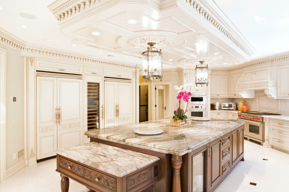 Inspiration for a large traditional u-shaped separate kitchen in New York with a drop-in sink, shaker cabinets, distressed cabinets, quartz benchtops, beige splashback, ceramic splashback, stainless steel appliances, with island, white floor, beige benchtop and wood.