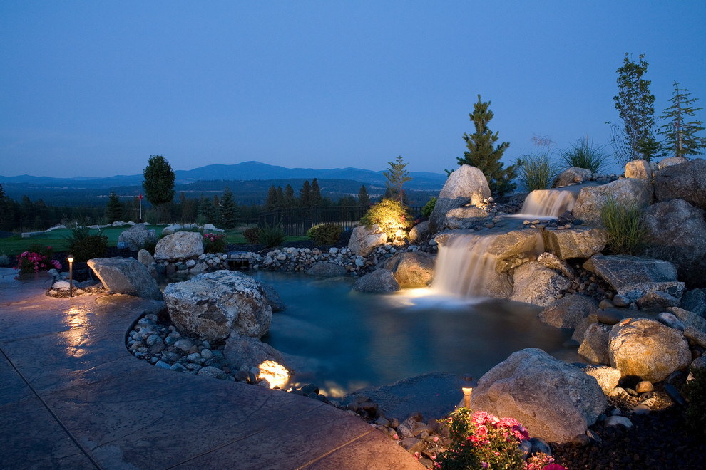 Photo of a large traditional garden in Seattle with a water feature and natural stone pavers.